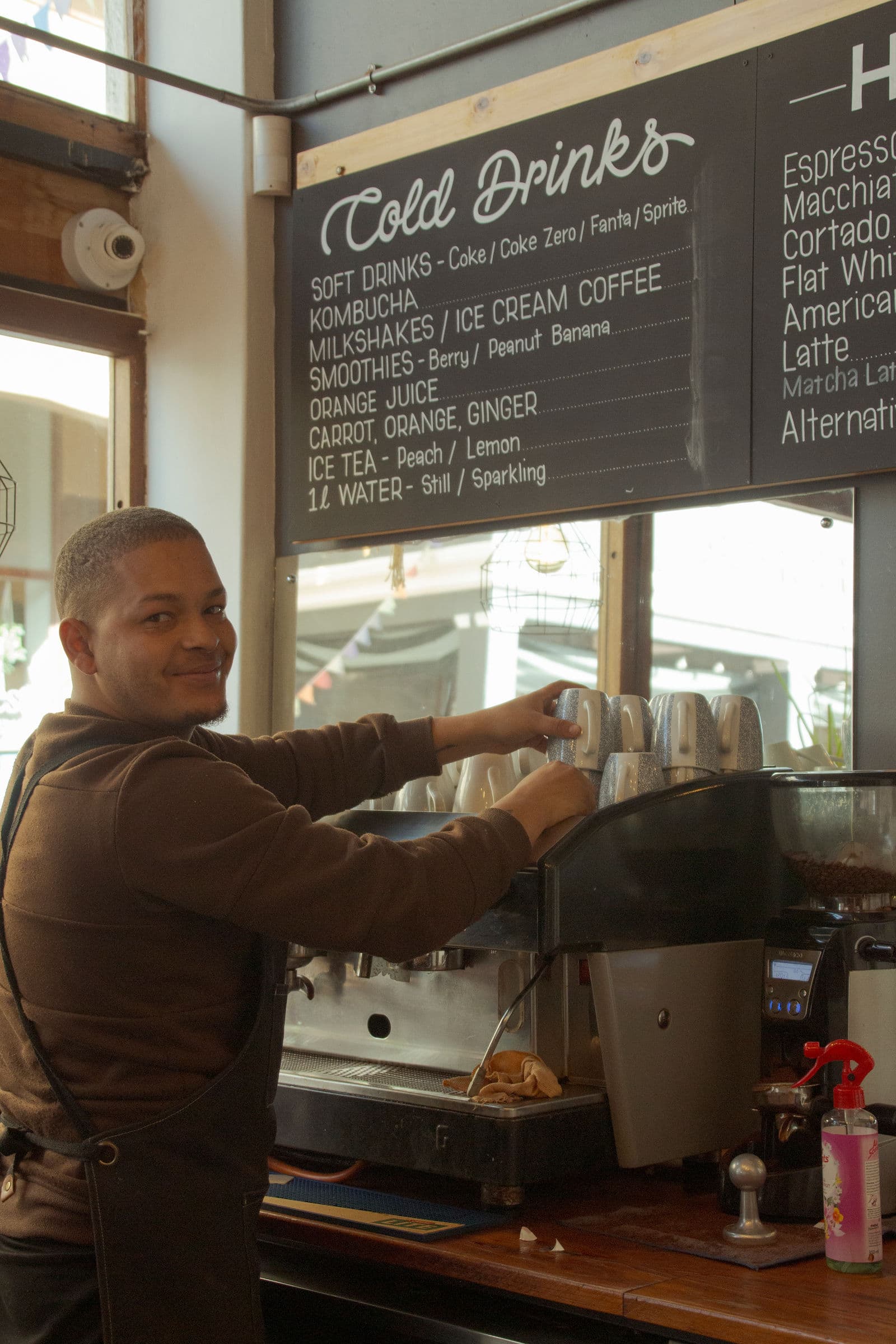 A barista at the espresso machine at Empire Cafe, Muizenberg
